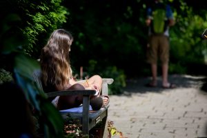 person on bench writing