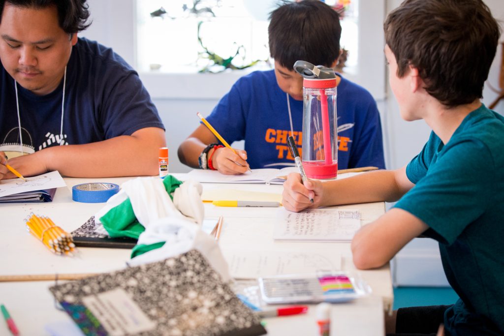 young writers around a table