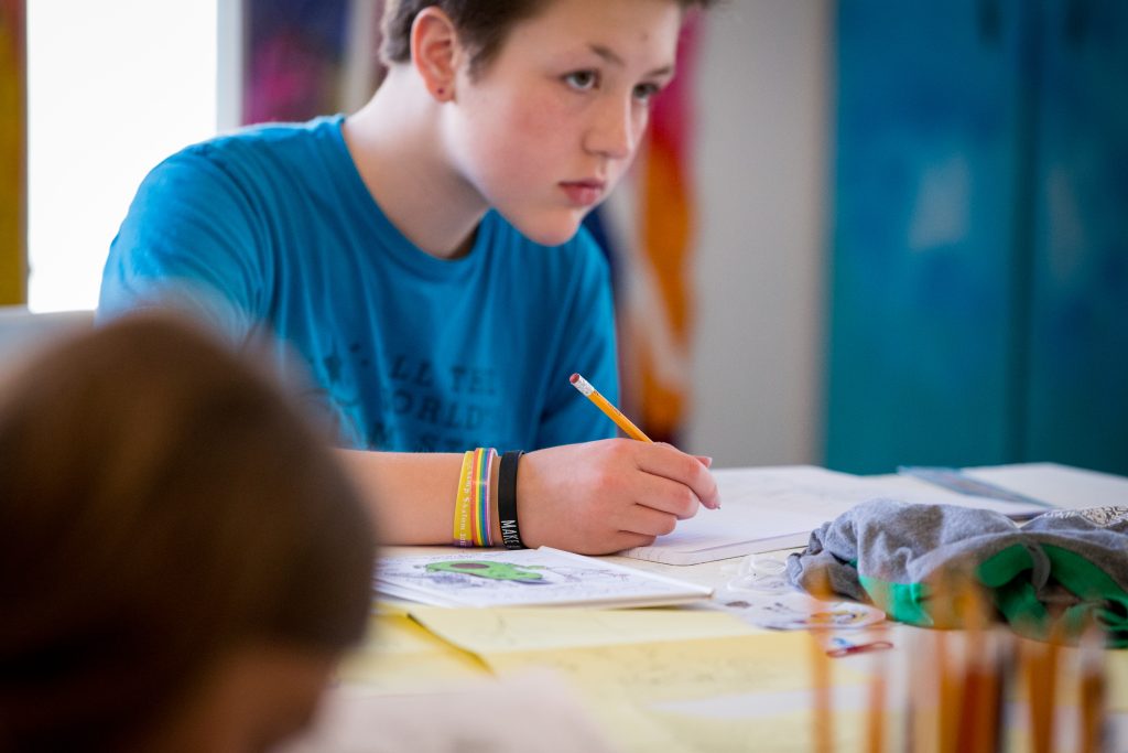 young writers around a table