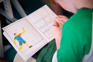 child drawing in sketch book
